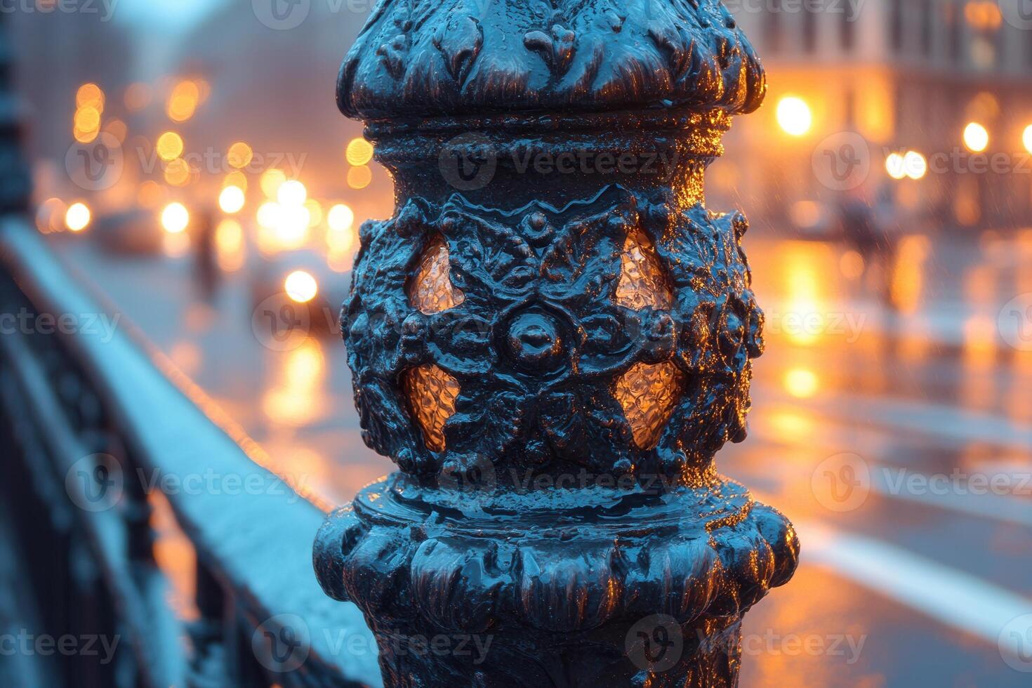 Ornate lamp post detail illuminated in urban setting. photo
