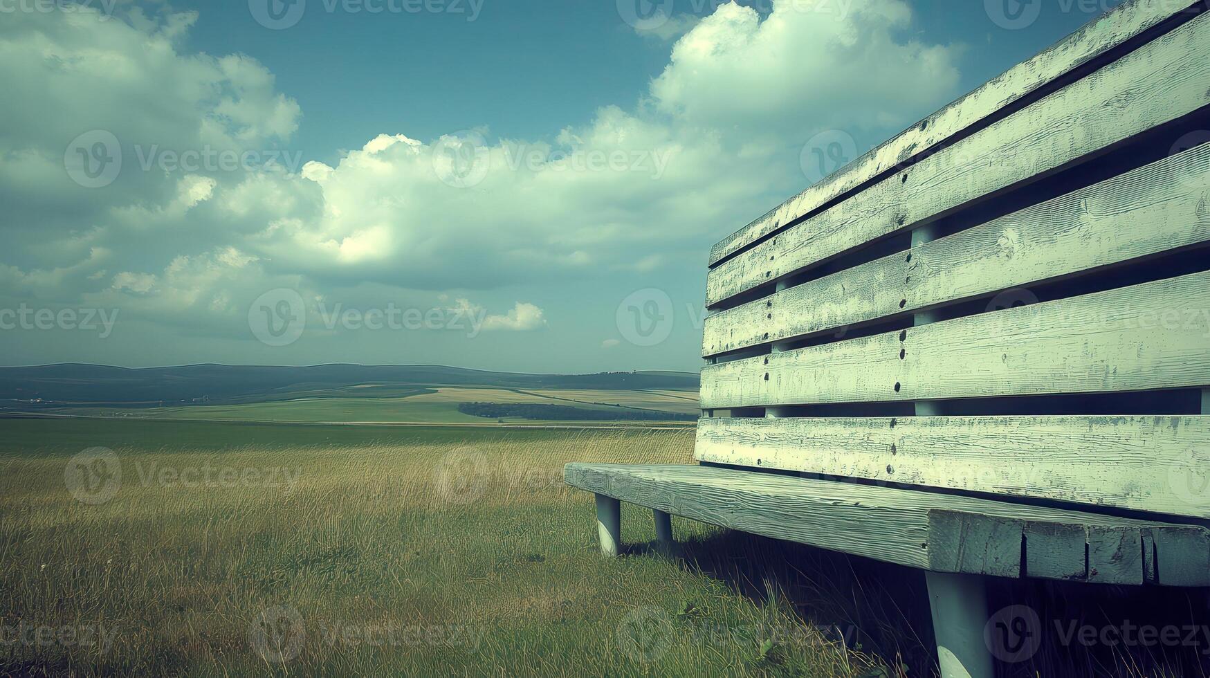 Rustic bench, scenic field, summer sky, peaceful view, relaxation photo