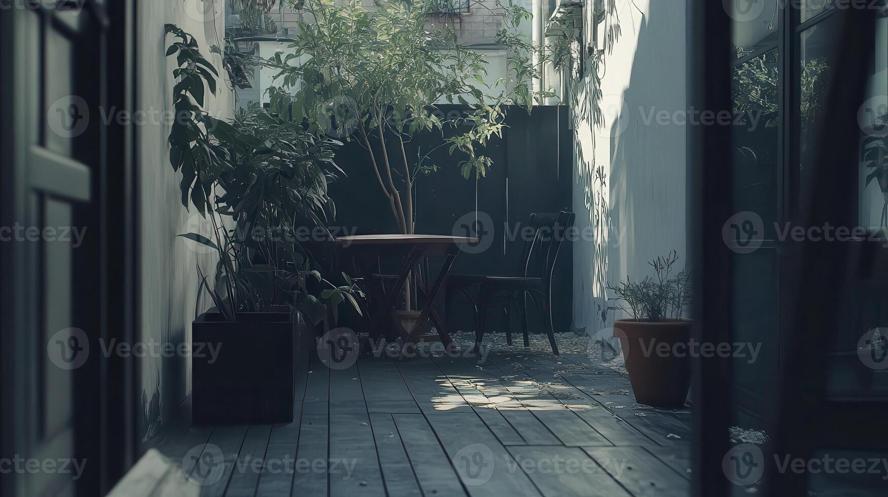Sunlit urban patio with plants, table, chairs photo