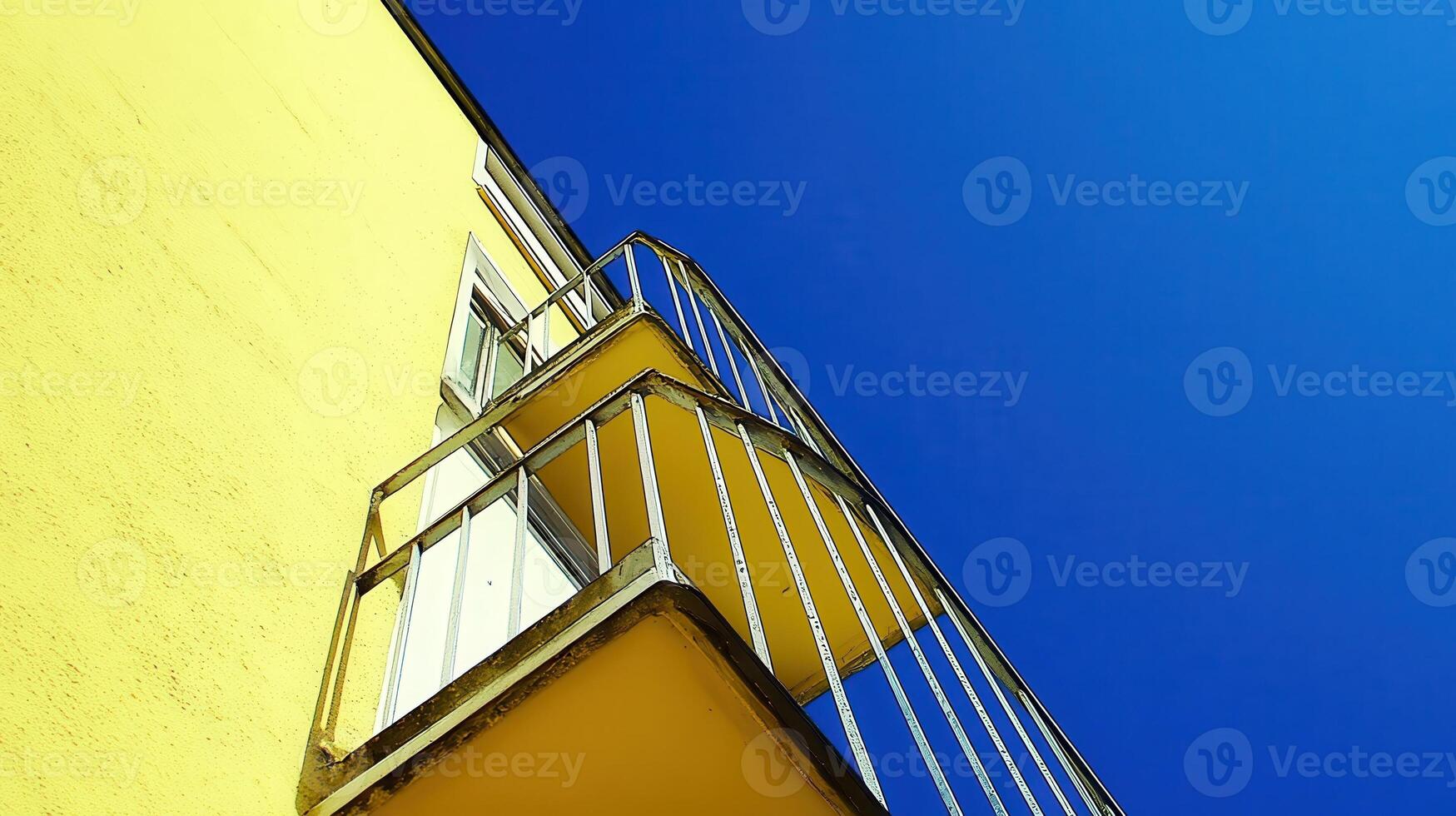 Yellow building balcony, blue sky, urban view photo