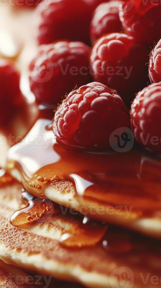 Close Up of Stacked Pancakes with Raspberries and Maple Syrup photo