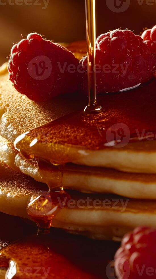 Delicious Stack of Pancakes with Raspberries and Maple Syrup photo