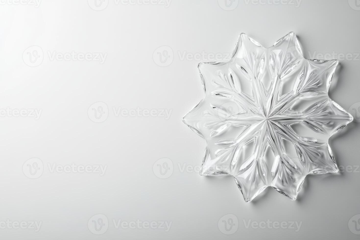 Glass snowflake decor with intricate design on white surface photo
