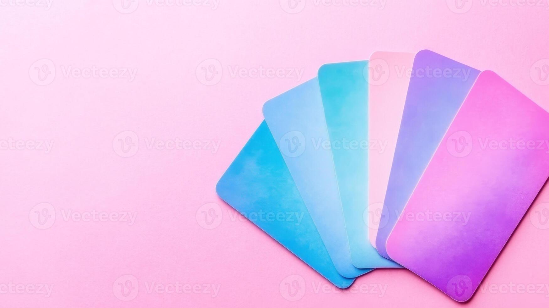 Assorted pastel color samples on pink backdrop photo