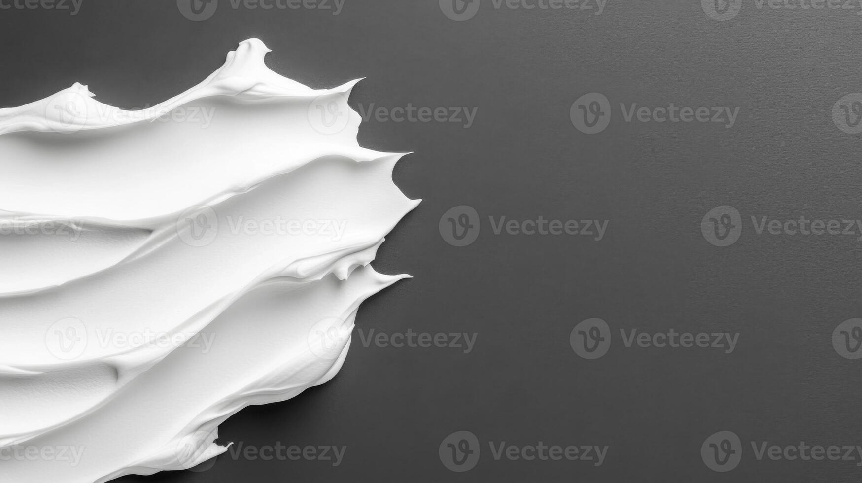 White cream strokes on dark surface photo