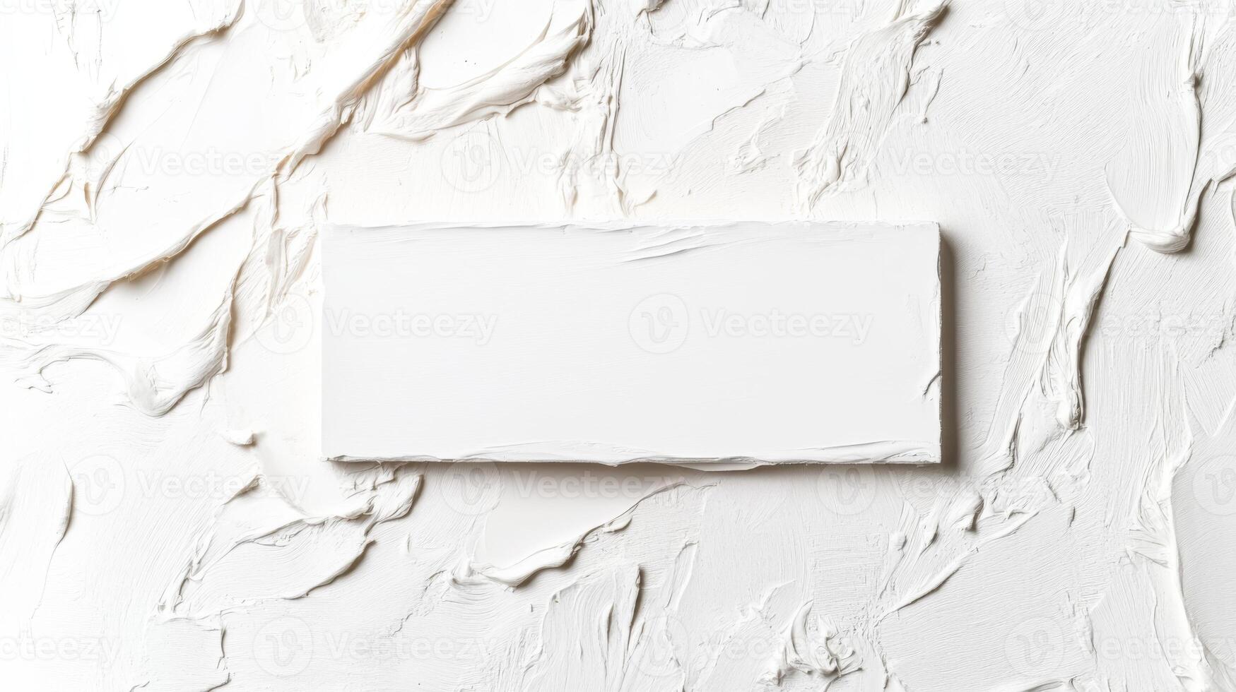 White torn paper rectangle on textured surface photo