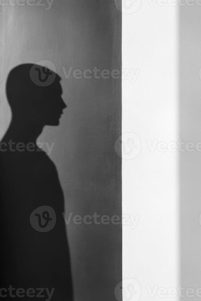 Human Silhouette on Gray and White Wall with Light Contrast photo