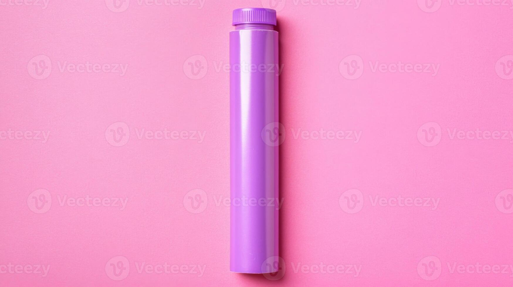 Simple Purple Plastic Tube Container Isolated on Pink Background photo