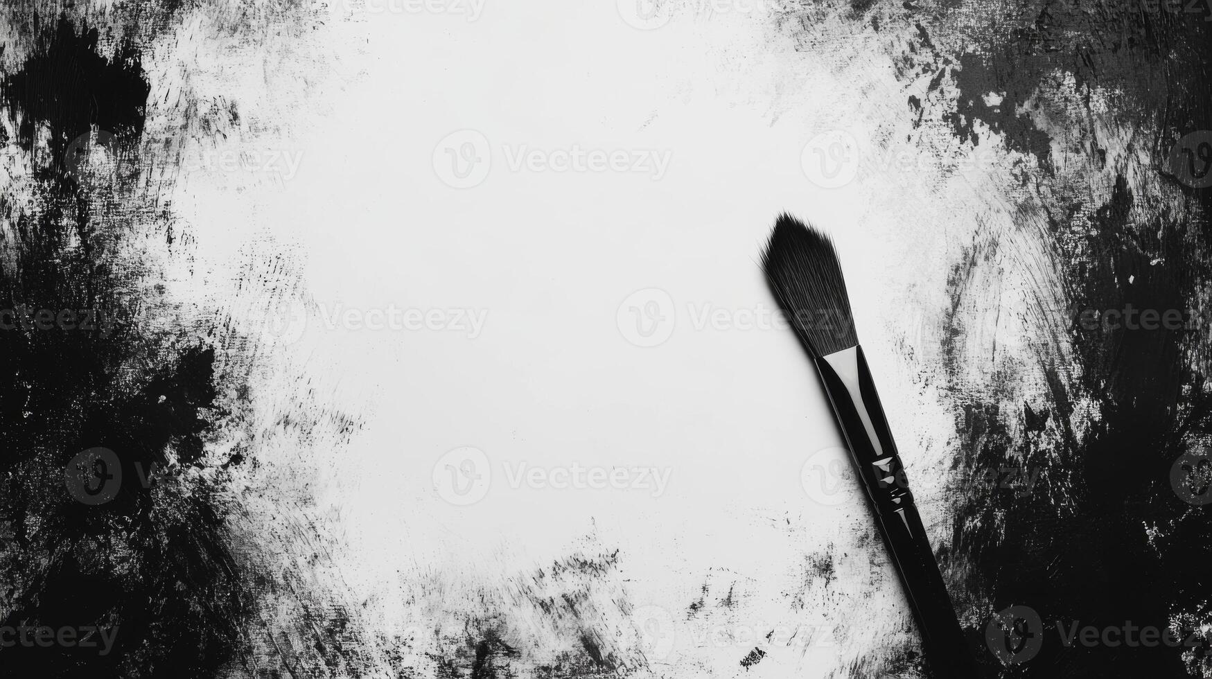 Artistic Brush Resting on a Canvas with Bold Black and White Strokes photo