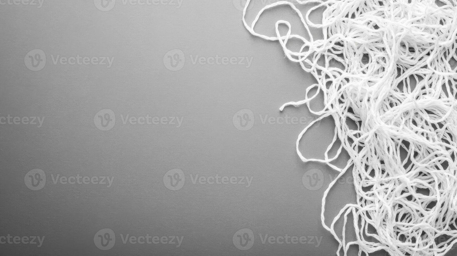 White threads randomly scattered on a gray background photo