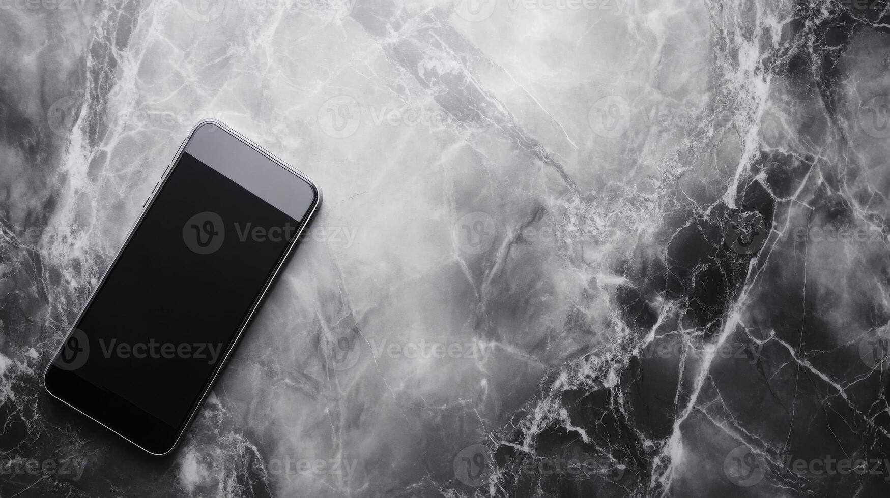 Black smartphone lying on a textured marble surface photo