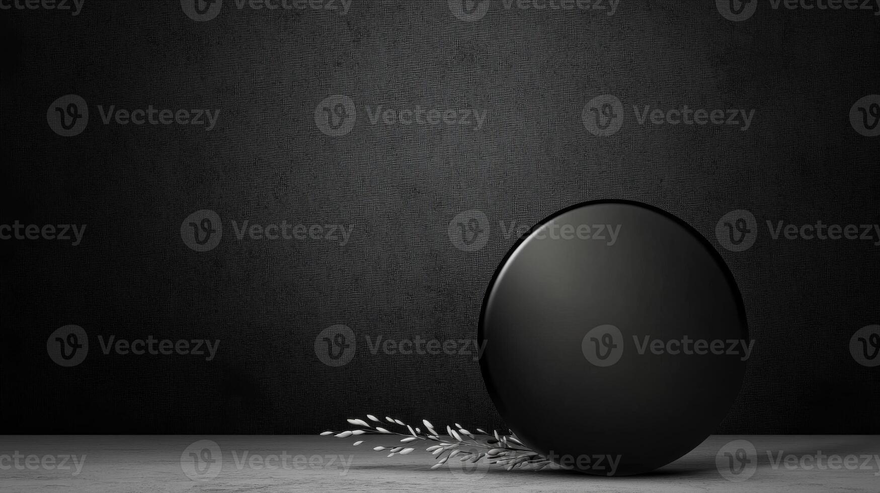 Glass Sphere and Delicate Sprig on Dark Textured Surface photo
