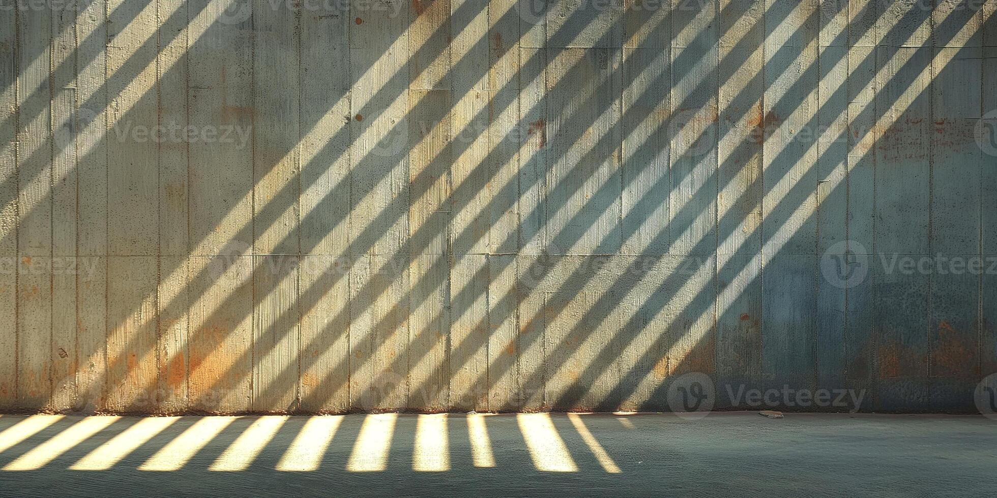 A textured concrete wall illuminated by dramatic shadows, creating a striking visual of light and pattern. photo
