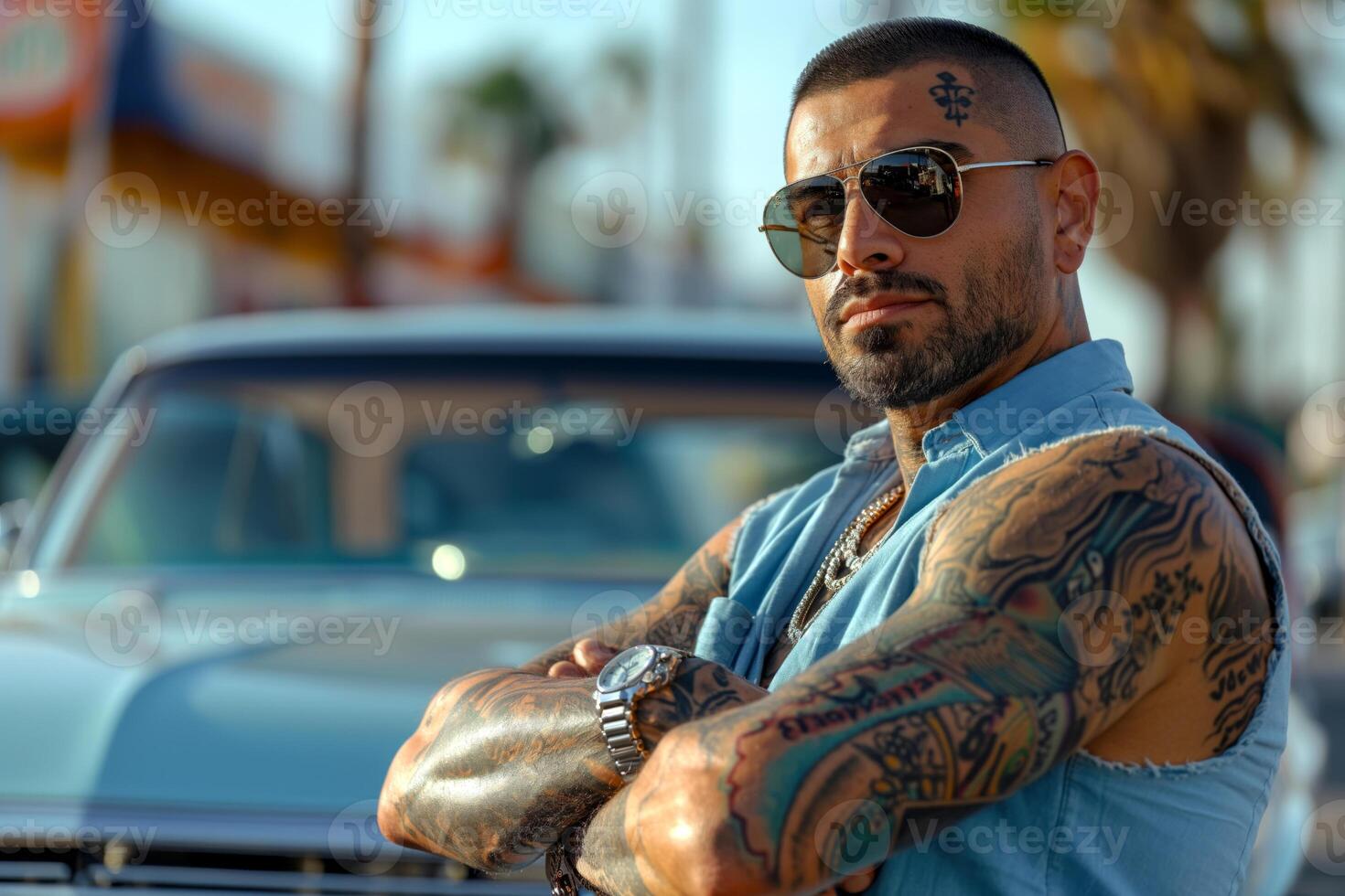 A stylish Hispanic man with tattoos poses confidently in front of a vintage car, exuding a cool and bold vibe. photo
