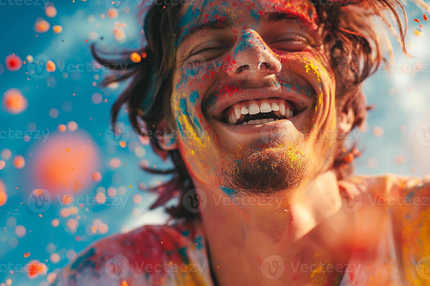 Joyful Hispanic male covered in colorful powder enjoying a vibrant celebration. photo