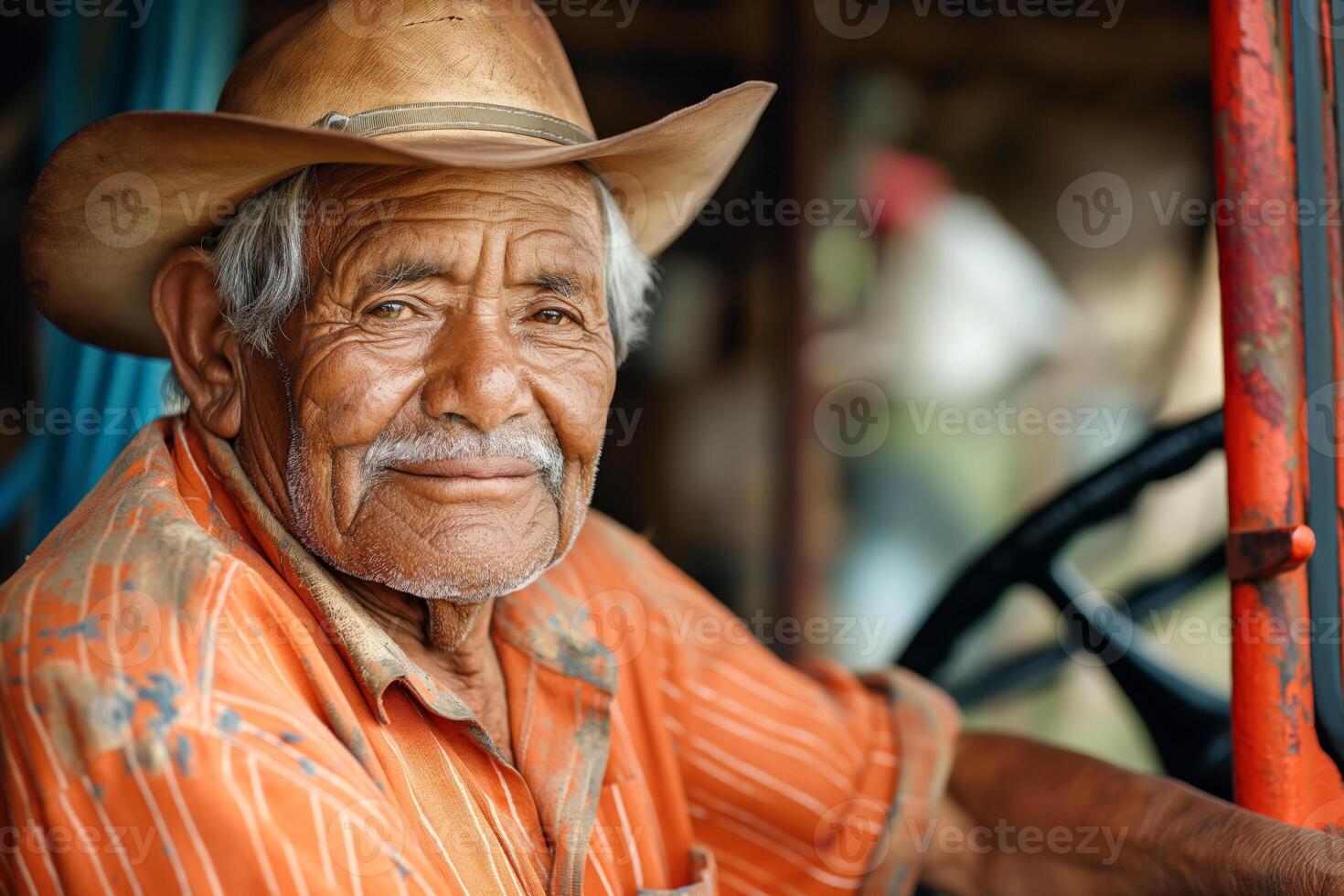 Smiling elderly Hispanic man in a cowboy hat, showcasing a warm, weathered face while sitting near a tractor. photo