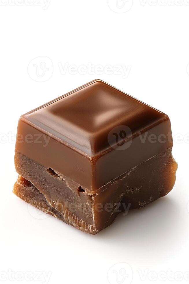A close-up of a rich, glossy chocolate caramel cube on a white background. photo