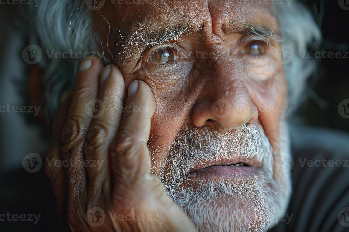 An elderly Hispanic man gazes thoughtfully, his weathered face reflecting a lifetime of experiences and emotions. photo