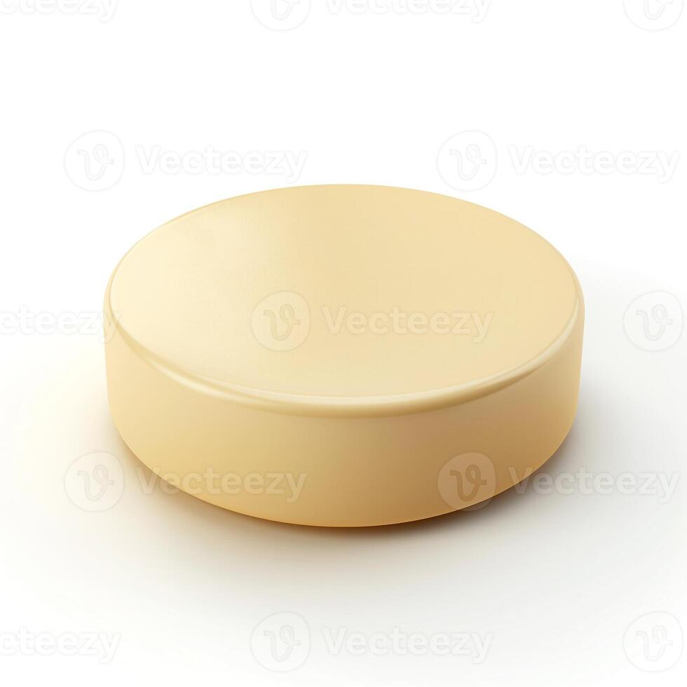 A smooth, round, pale yellow disc resembling a block of butter or cheese, isolated on a soft white background. photo