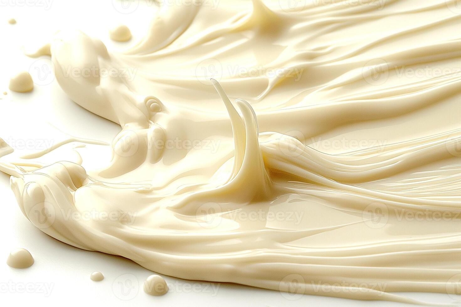 Smooth and creamy texture of a light beige substance spread across a white background. photo