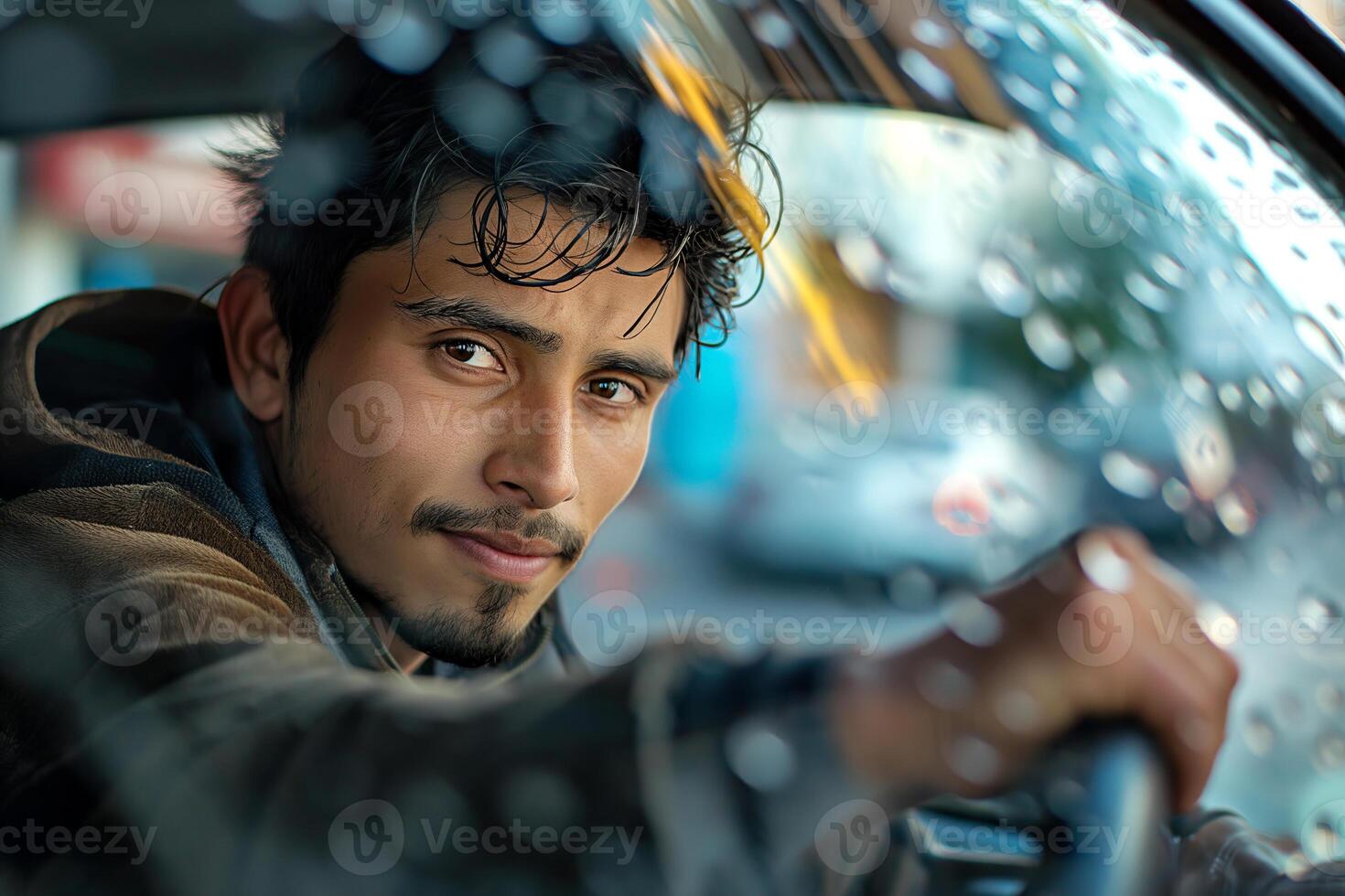 A young South Asian man with a thoughtful expression driving a car, rain droplets on the window adding a moody atmosphere. photo
