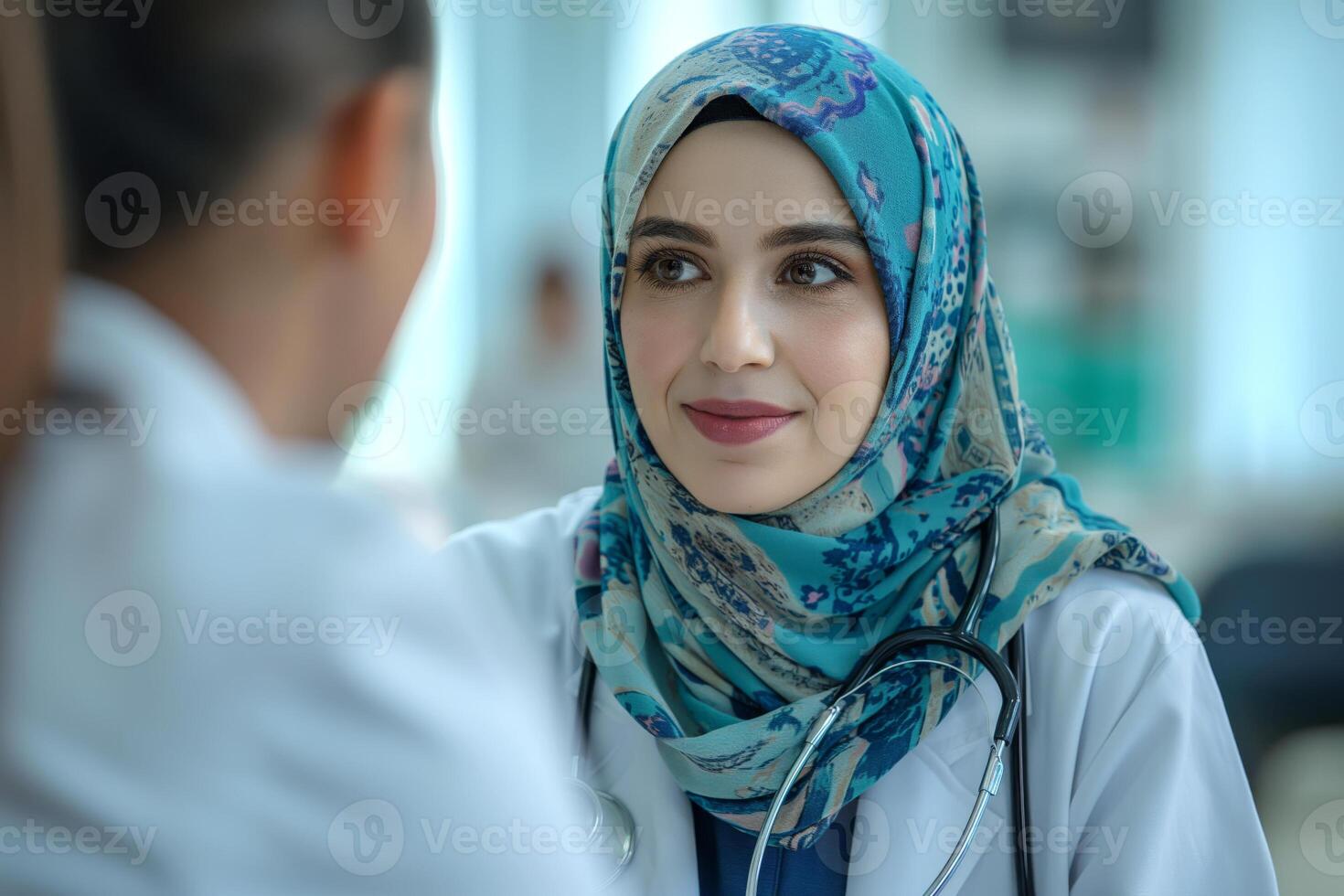 A confident Middle Eastern female doctor in a hijab listens attentively during a patient consultation, showcasing compassion and professionalism. photo