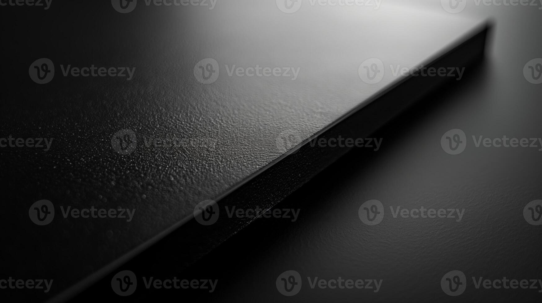 Close-up of a sleek, textured black surface, emphasizing minimalist design and elegance. photo