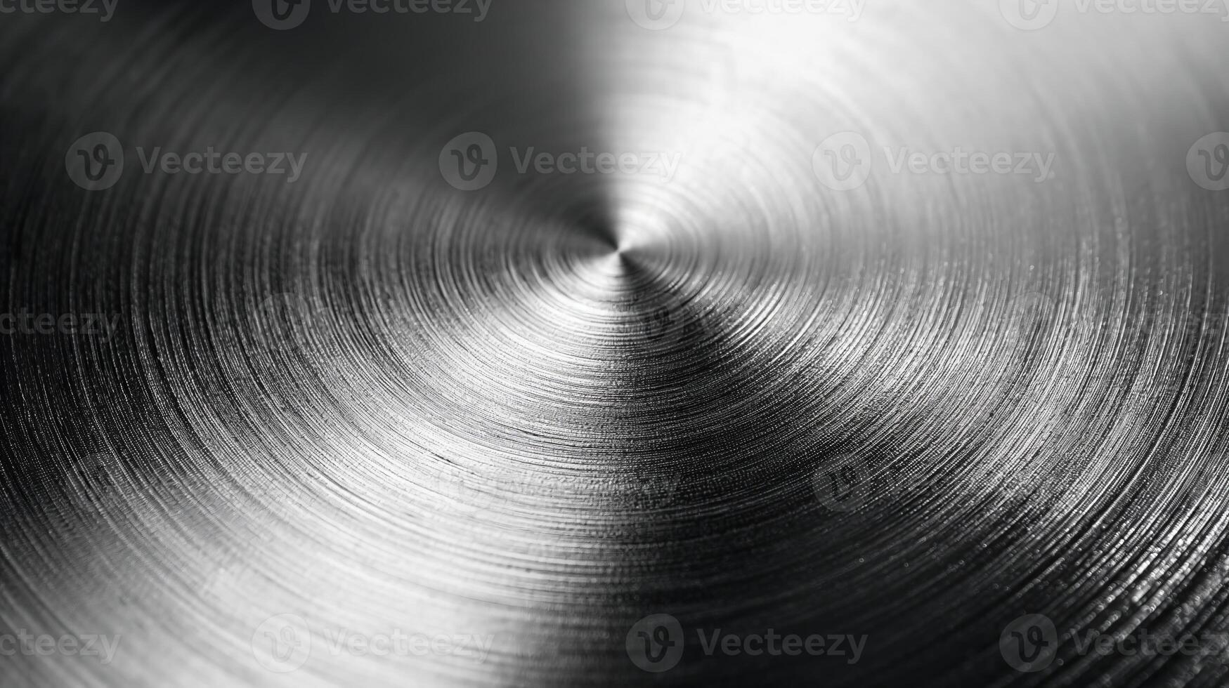 A close-up view of a polished metallic surface displaying fine circular patterns. photo