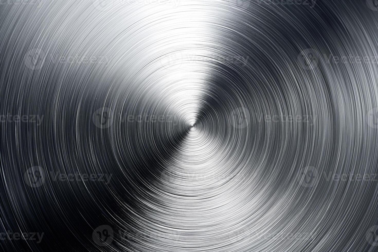 A close-up of polished metal with a swirling pattern, showcasing a smooth, reflective surface. photo