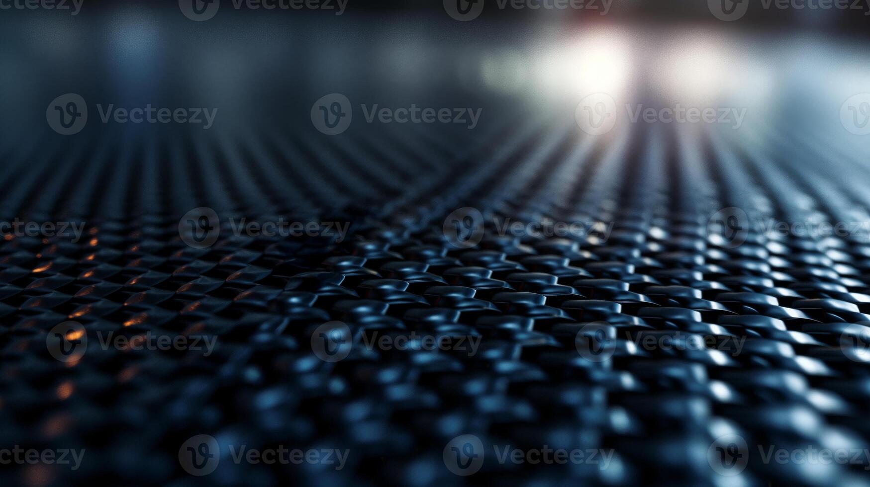 Close-up of a textured black surface with intricate patterns reflecting light, creating a dynamic visual experience. photo