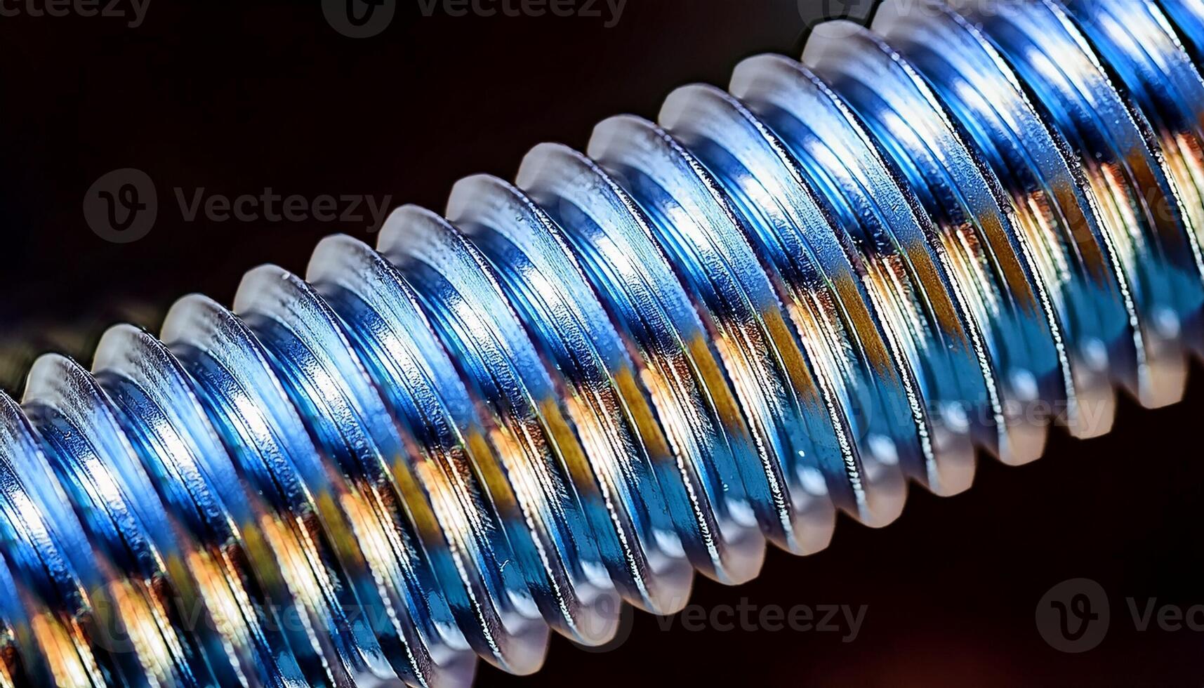 Close-up View of a Shiny Metallic Screw Thread Revealing Intricate Details and Reflective Surfaces photo