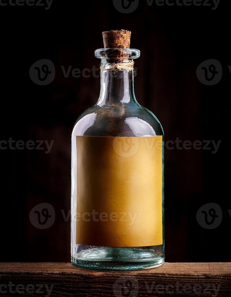 Glass Bottle With Blank Label Sitting on Wooden Surface Illuminated by Soft Light photo