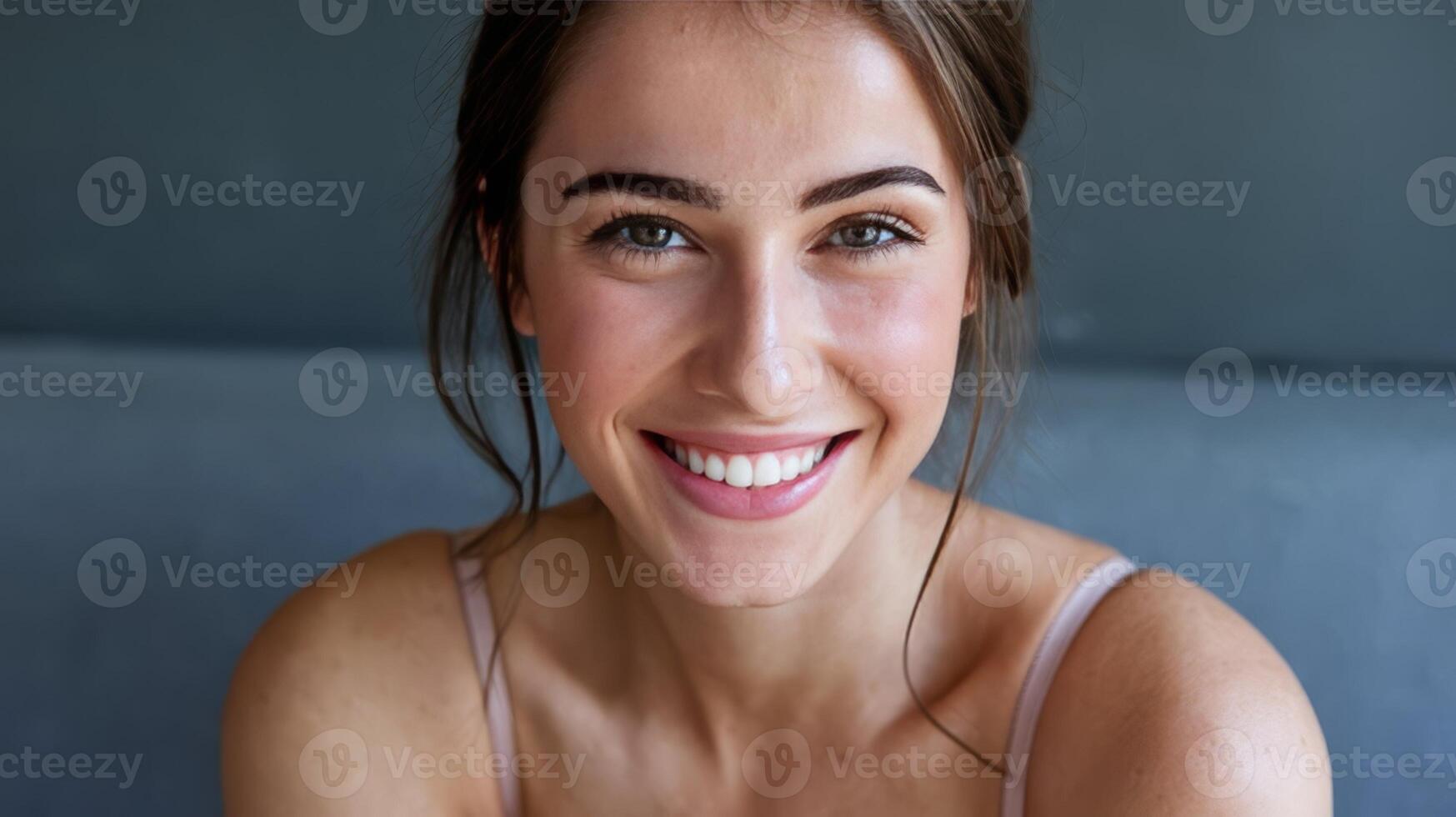 A woman smiling with her teeth showing photo