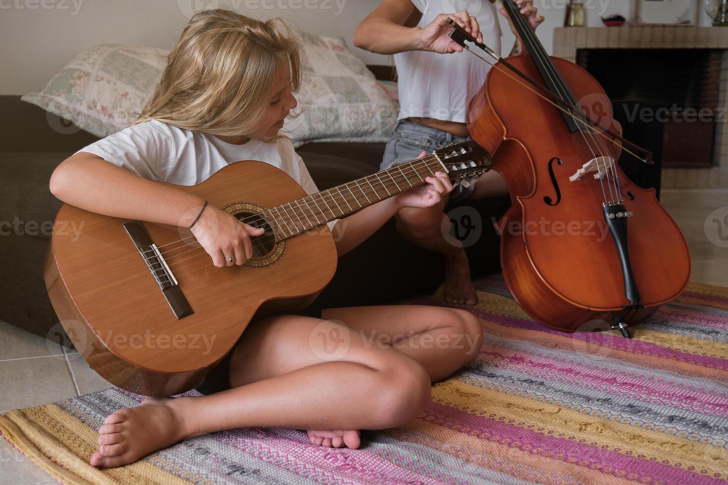 Mother and daughter playing musical instruments together at home photo