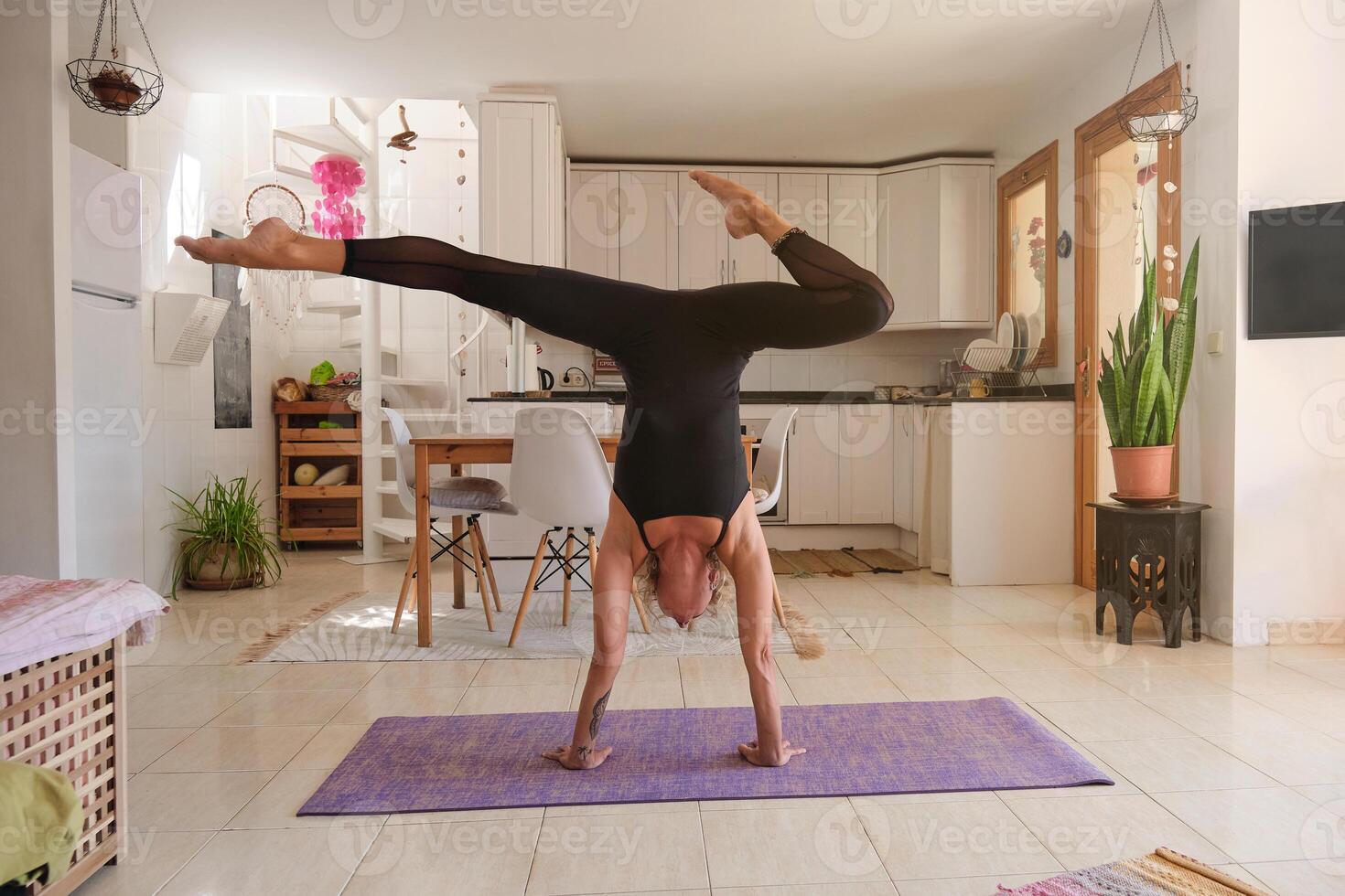 Slim woman doing yoga on mat at home photo