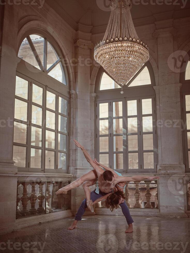 Bended dancer with ballerina on back in palace photo