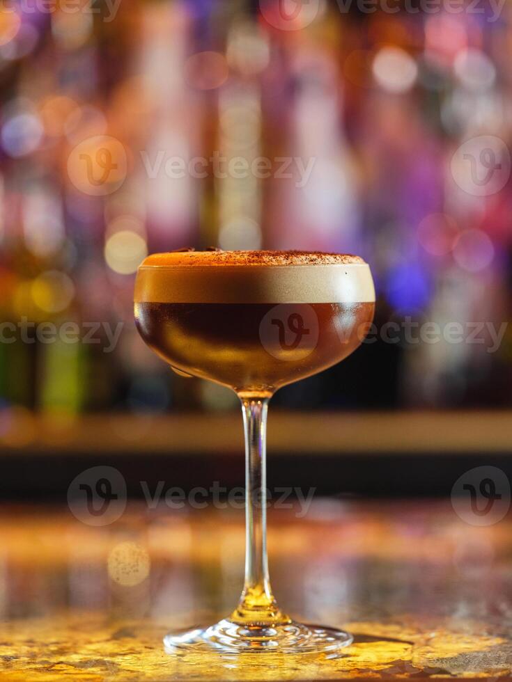 Frothy espresso martini cocktail in bar photo