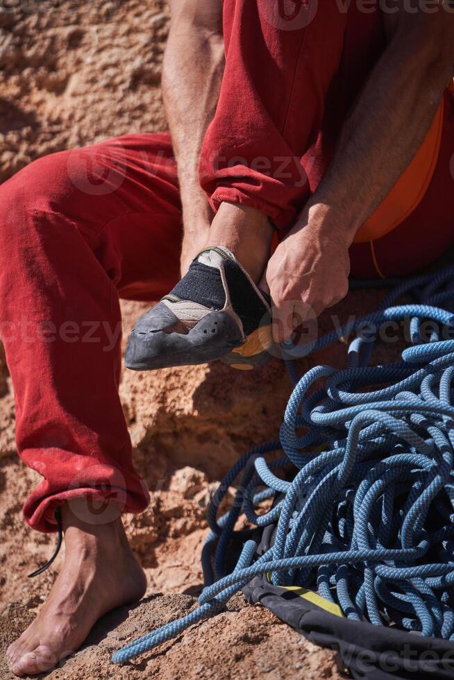 Unrecognizable putting on climbing shoes photo