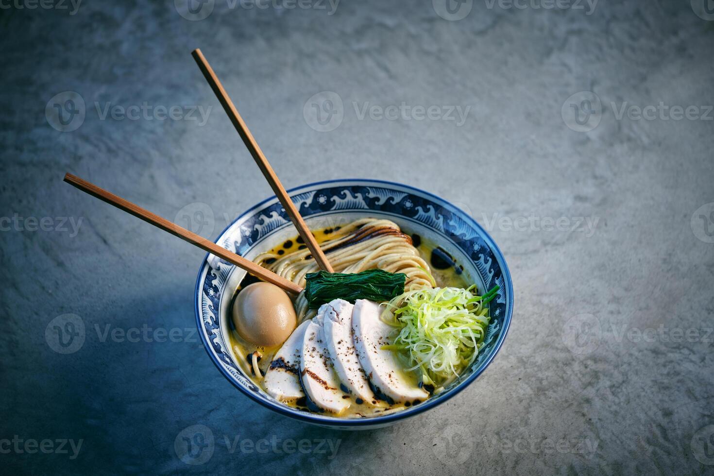 Delicious ramen with chicken fillet slices and boiled egg photo