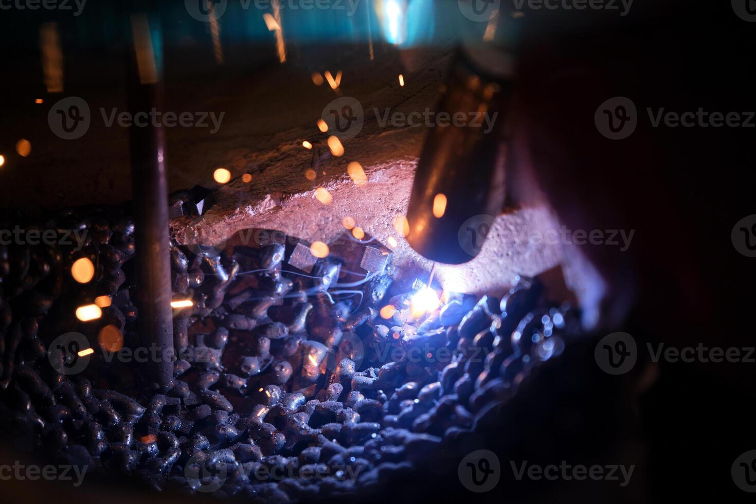 Welder joining metal in plaster mold photo