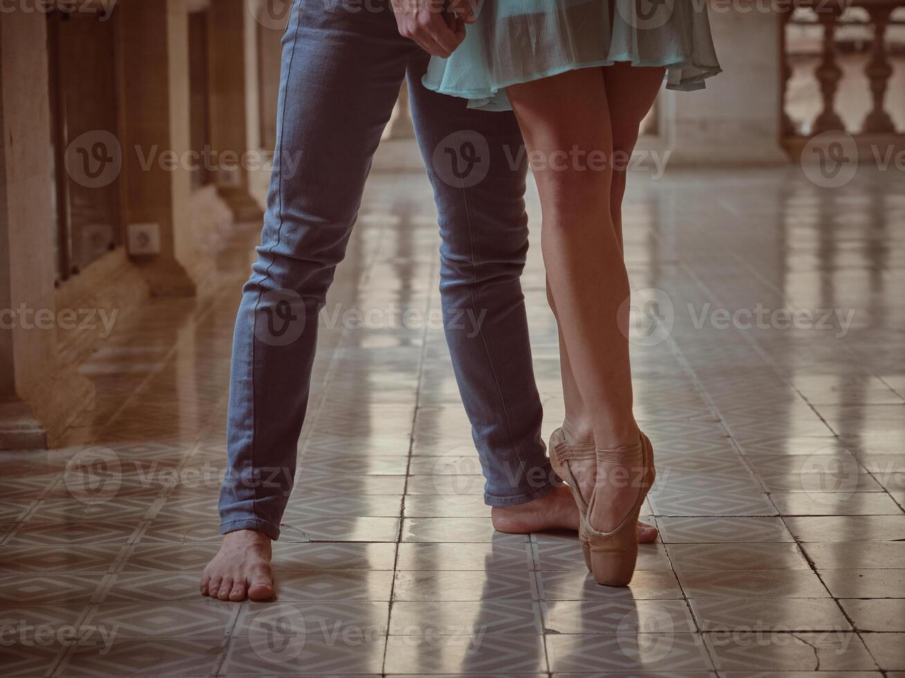 Crop ballerina with male dancer on tiled floor photo