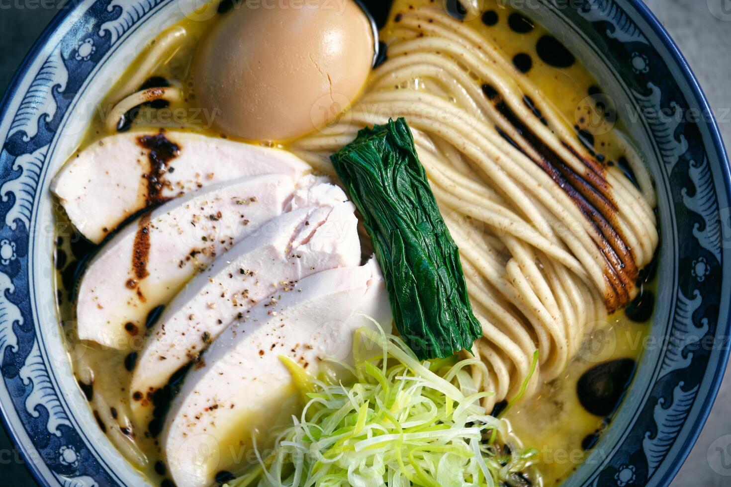 Delicious ramen with chicken fillet slices and seaweed photo
