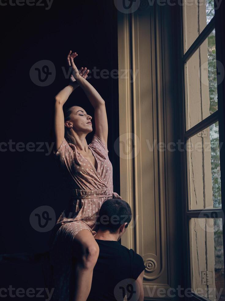 Attractive ballerina on shoulder of faceless dancer photo