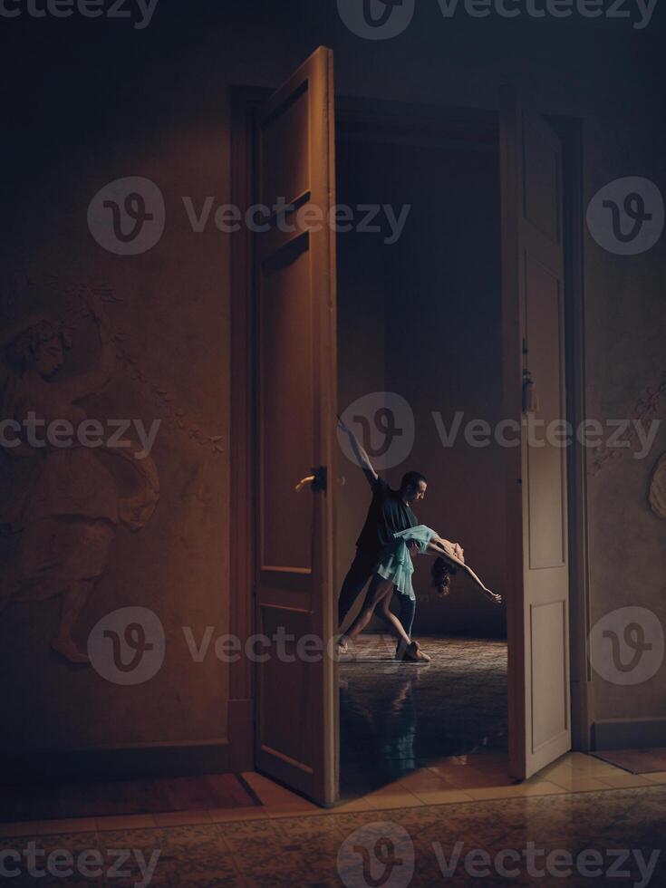 Anonymous female and partner dancing in empty room photo