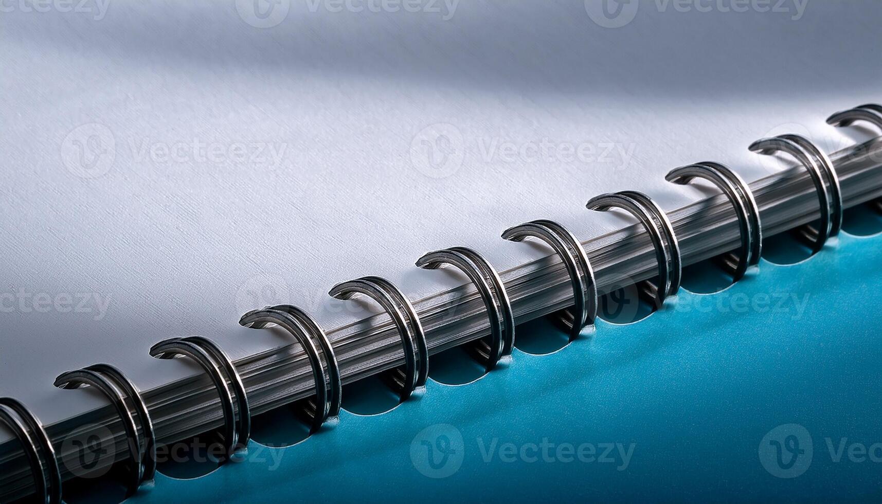 Spiral Notebook Showcasing Metallic Rings and Clean Pages With Soft Shadows and Vibrant Blue Background photo