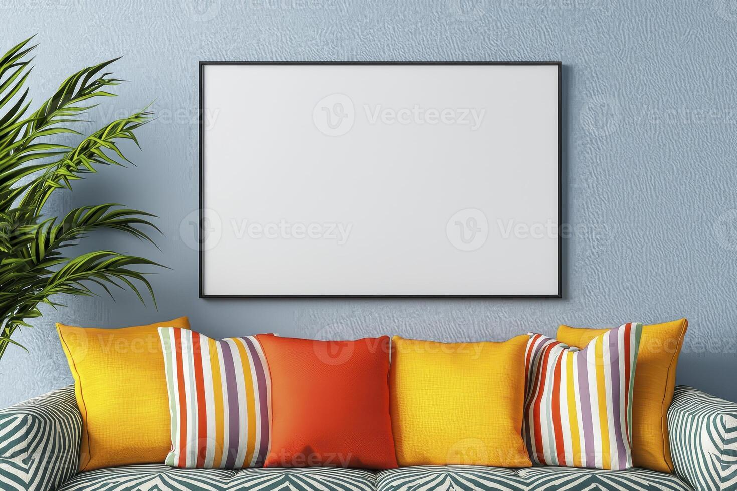 A blank frame sits on a couch in front of a blue wall photo