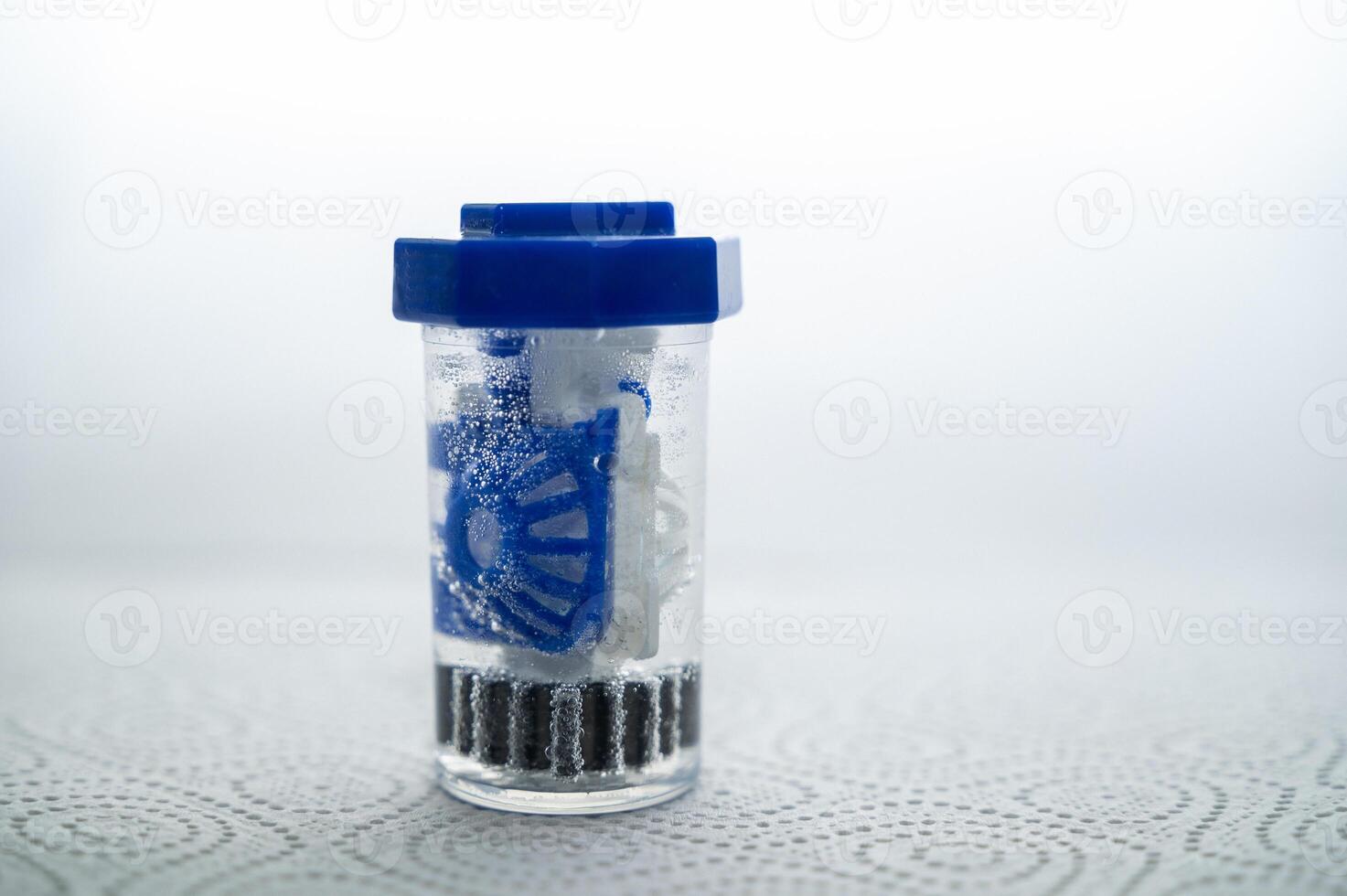 close-up of a container for cleaning and storing contact lenses for the eyes, used at home. For soft and hard lenses. The container is in the active cleaning process. the container is closed. photo