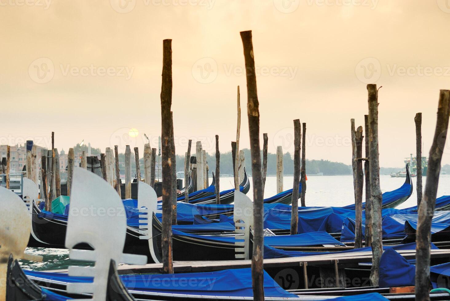 Gondolas moored by Saint Mark square with San Giorgio di Maggiore church in the background - Venice, Venezia, Italy, Europe photo