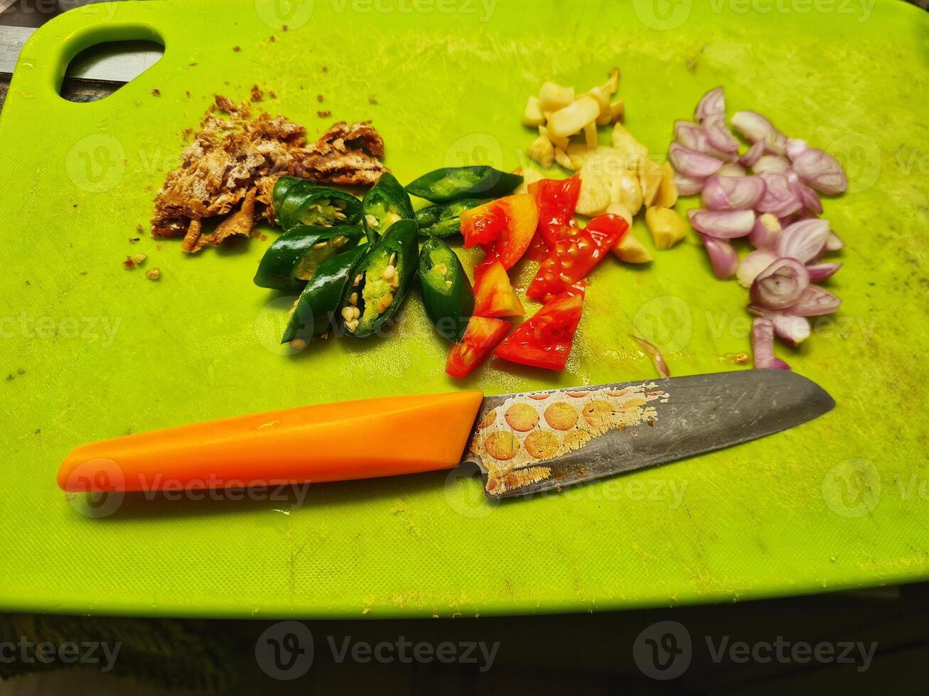 A knife on a cutting board photo