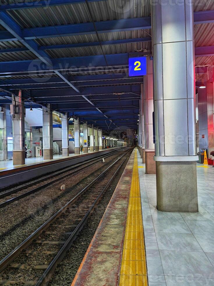 A train station with a train on the tracks photo